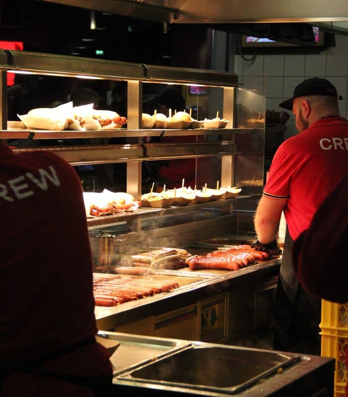 Chef preparing food with care and precision at the grill station