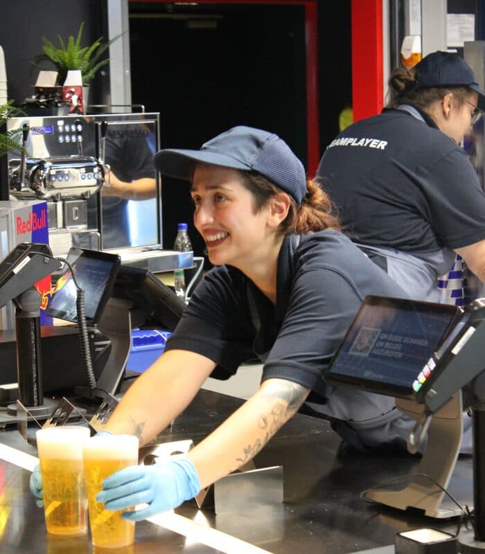Bartender serving guests with a smile at a live event